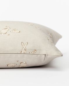 a white pillow with rabbits on it