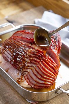 the ham has been cooked and is being drizzled with sauce on it