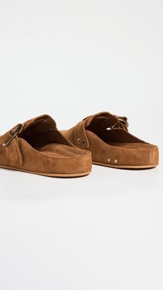 Find BEEK Vulture Clogs on Editorialist. Upper: Cowhide suede. Lining: Leather. Molded footbed. Antiqued hardware. Buckle strap. Round toe. Rubber sole. Imported, Mexico. This item cannot be gift-boxed. Suede Slip-on Clogs With Buckle Closure, Suede Slip-on Mules With Buckle Closure, Suede Closed Toe Clogs With Buckle Closure, Closed Toe Suede Clogs With Buckle Closure, Chic Brown Suede Mules, Chic Brown Mules With Rubber Sole, Brown Suede Clogs With Flat Heel, Brown Flat Heel Clogs With Buckle Closure, Brown Leather Mules With Buckle Closure