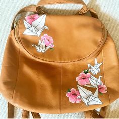 an origami bag with flowers and birds on it