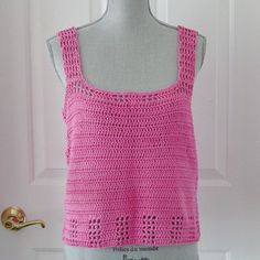 a crocheted tank top is displayed on a mannequin