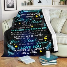 a blanket with the words i love you in different languages on it, sitting next to a couch