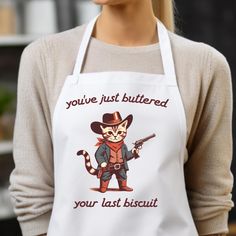 a woman wearing an apron that says you've just buttered your last biscuit