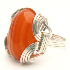 "Handmade Cabochon Ring Sterling Silver Wire Wrap Red and white Sardonyx Gemstone Ring Sizing and shipping is ALWAYS FREE with a 14 day \"No Questions Asked\" return policy. Gemstone sizes available: XS (16x12mm 5/8x1/2 inch) S (18x13mm 3/4x1/2 inch 10+ct) M (25x18mm 1x3/4 inch 20+ct) L (30x22mm 11/8 x7/8 inch 25+ct) *In the notes section of your order, please specify ring size and gemstone size (XS-S-M-L).* This ring is made with real gems. I made it myself, so if you see a setting you like and Handmade Red Oval Cabochon Jewelry, Orange Agate Cabochon Jewelry, Adjustable Orange Cabochon Jewelry, Adjustable Red Cabochon Jewelry, Red Hand Wrapped Round Jewelry, Hand Wrapped Red Round Jewelry, Hand Wrapped Round Red Jewelry, Red Adjustable Wire Wrapped Rings, Adjustable Red Wire Wrapped Rings