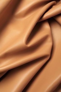 a close up view of a tan leather textured material that is soft and smooth