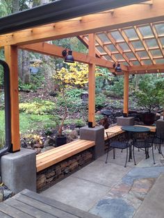 an outdoor dining area with wooden benches and tables