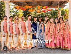 a group of people standing next to each other in front of a gazebo at a wedding