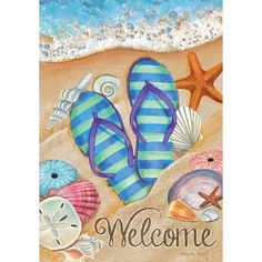 a welcome sign with flip flops, starfish and seashells on the beach