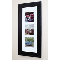 a black framed photo hanging on the wall next to a blue and white car parked in front of it