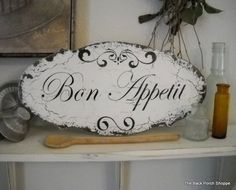 a sign that says bon appeti on it next to other kitchen utensils