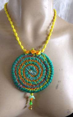 a woman's torso wearing a necklace made with beads and bead work on it