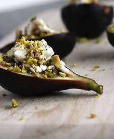 an eggplant stuffed with cheese and other toppings on a wooden cutting board