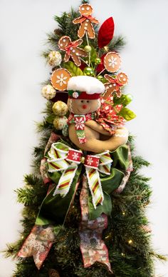 a christmas tree decorated with gingerbreads, cookies and candy canes in the shape of a teddy bear