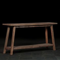 a wooden bench sitting on top of a black floor