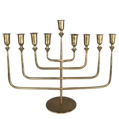 a golden menorah with five candles on it