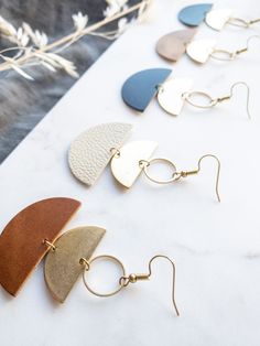 Cozy vibes in one of our best selling earrings shapes! This beige leather is soft, neutral and perfect for a delicate statement. •••••••••••••••••••••••••••••••••••••••••••••••••••••••••••••• • ORDERING • These leather earrings measure approx 1 1/2" wide, 2 3/4" drop with hook. These earrings come with raw brass or 14K gold fill hooks, and feature raw brass accents. Please note raw brass will naturally oxidize over time, creating a beautiful vintage like patina on your earrings. Each pair of ear Minimalist Everyday Beige Jewelry, Everyday Minimalist Beige Jewelry, Everyday Beige Dangle Earrings, Minimalist Leather Earrings For Everyday, Beige Dangle Earrings For Everyday, Beige Dangle Jewelry For Everyday, Adjustable Beige Earrings For Everyday, Chic Brown Earrings For Everyday Wear, Everyday Beige Dangle Jewelry