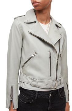 Rock a classically cool look with this buttery-soft leather moto jacket featuring silvertone hardware and a buckle belt to adjust the fit. 20" length (size 8) Asymmetrical front-zip closure Notch lapels Long sleeves with zip cuffs Front zip pockets Epaulets Buckle belt Lined Leather Professional leather clean Imported t.b.d.