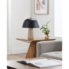 a table with a lamp on it next to a couch