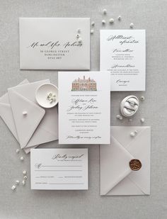 the wedding stationery is laid out and ready for guests to arrive