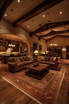 a living room filled with furniture and a large rug on top of a hard wood floor