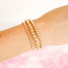 Looking for a basic to start your stack? Wanting to add to your current collection? You’ve come to the right place. These are a staple in your beaded stack. Our gold stackable beaded bracelets are available in a variety of bead sizes and lengths to fit every wrist. Made from 14 k gold filled beads so perfect for everyday wear! Sweat proof, waterproof and tarnish free! Size: Standard (6.75 inches) | Extended (7.25 inches) | Extended Plus (8 inches) These bracelets are handstrung with love in Coll Trendy Gold Stackable Stretch Bracelet, Gold Stackable Beaded Bracelets For Layering, Gold Bracelets With Round Beads For Layering, Gold Stackable Stretch Bracelet For Layering, Gold Trendy Stretch Bracelet With Spacer Beads, Gold Stackable Wrap Bracelet For Stacking, Gold Stretch Bracelet For Layering, Gold Bracelets With Tiny Beads For Layering, Trendy Gold Stretch Bracelet With Spacer Beads