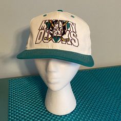 a white hat with green brimmed brim and the words mighty bears on it