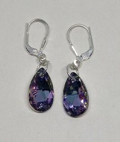 These beautiful sterling silver earrings have sparkling 16x9mm Swarovski Crystal Vitrail Light pear-shaped drops hung on a closure of your choice.Crystal Vitrail Light is a beautiful blend of pinks, purples, and blues that vary in intensity depending on the angle of light.Choose Closure: Fishhook Earwire or LeverbackEarwires come with rubber earnut backs in order to secure them on your ears; leverback have a secure attachment.**Matching Necklace Available Nickel Free Purple Teardrop Crystal Earrings, Nickel-free Purple Teardrop Crystal Earrings, Purple Teardrop Crystal Earrings In Sterling Silver, Purple Sterling Silver Teardrop Earrings, Purple Teardrop Crystal Earrings With Ear Wire, Purple Teardrop Crystal Earrings, Crystal Teardrop Earrings, Secure Attachment, Mirror Ornaments