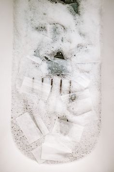 an image of snow and ice in a glass container with some papers on the bottom