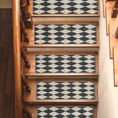 the stair treads are made from wood and have black and white designs on them