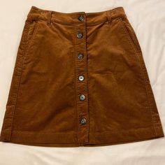 Brown, Button Down Corduroy Skirt. Never Worn. Great Quality! Brown Corduroy Bottoms With Buttons, Fall Corduroy Button-up Bottoms, Casual Corduroy Skirt With Button Closure, Brown Cotton Skirt With Buttons, Casual Corduroy Button-up Bottoms, Fall Cotton Skirt With Buttons, Fall Cotton Skirt With Snap Buttons, Brown Corduroy Skirt, Skirts Brown