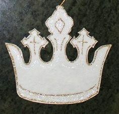 a white crown ornament hanging on a wall