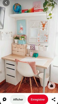 a white desk and chair in a room with wood flooring, bookshelves and pictures on the wall