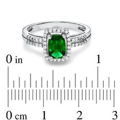 On her May birthday, dazzle her with a ring that's just her style! Crafted in fine sterling silver, this magnificent fashion ring features a glistening 7.0 x 5.0mm faceted cushion-cut, lab-created green emerald center stone that grabs the eye. Framing the emerald and lining the double shank, shimmering white sapphires are the just-right finishing touch. Custom made to fit her ring size. Sterling silver rings cannot be resized after purchase. Timeless Emerald Ring With Diamond Accents As Gift, Formal Halo Ring With May Birthstone Center Stone, Dazzling Gemstone Ring For May Birthstone, Dazzling Emerald Ring With Halo Setting For Promise, Dazzling Emerald Rings With Diamond Accents, Fine Jewelry With Diamond Accents For May Birthstone, Formal May Birthstone Diamond Ring With Halo Design, Classic Emerald Ring With Center Stone, May Birthstone Jewelry With Diamond Accents For Anniversary