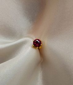 22k solid gold ear studs / karabu earring with red/ruby coloured Cubic zirconia. The stone is available in 2mm, 2.5mm and 3mm size. This Cubic Zirconia has AAAAA rating. This earring comes with screw back closure. Our 22k jewelleries are genuine real gold. This is a special gift for baby, child, girlfriend, wife, daughter, mum, family or friend. It is a perfect gift for Christmas, New year, Valentines day, christening, birthday, wedding, anniversary and any special occasion.. Each item is packag