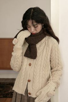 Cozy round neck cardigan with a braided knit pattern. One Size: 42.5" chest, 23" length