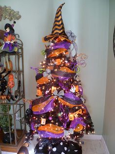 a halloween tree decorated with purple and orange ribbons