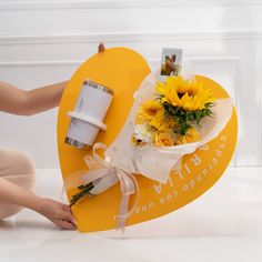 a heart shaped box with sunflowers on it