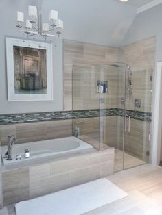 a bathroom with a large tub and walk in shower