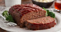 meatloaf with sauce and broccoli on a plate