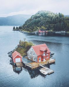 an island with a house on it in the middle of water