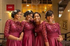 three women in red dresses posing for the camera with their arms around each other and smiling