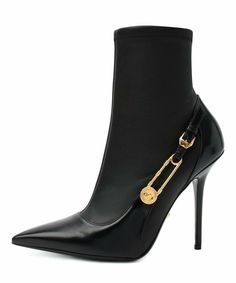 Versace Medusa Safety Pin Stretch Leather Pointed toe Ankle Boots Color: Black Size:  36.5 Ankle-high buffed leather heeled boots in black. Pointed toe. Strap featuring crystal-embellished signature Medusa safety pin hardware and pin-buckle fastening at outer side. Covered stiletto heel. Signature Medusa hardware at leather outsole. Gold-tone hardware. Approx. 4.25 heel. Made in Italy Evening Heeled Boots With Metal Feet, Winter Evening Boots With Metal Feet, Evening High Heel Boots With Metal Feet, Evening High Heeled Boots With Metal Feet, Evening Heeled Boots With Metal Feet And Pointed Toe, Versace Platform Boots, Versace Boots Heels, Versace Medusa Heels, Versace Cross Boots