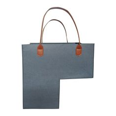 a blue bag with two brown handles on the front and bottom, sitting against a white background