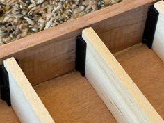 two pieces of wood sit on top of a carpeted floor next to each other