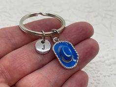 Cowboy Hat Keychain, Cowgirl Hat Keychain, Personalized Keychain, Initial Keychain, Cowboy Hat Charm, Initial Charm, Initial Key Ring Express yourself with a beautiful piece of charm jewelry or find the perfect gift for that special person! This keychain features a blue enamel and silver cowboy or cowgirl hat charm and an initial charm *Charms are made from a zinc alloy metal and are lead and nickel free. 🌺I offer 5 different styles of initials (the keychain is shown with the stamped circle sty Handmade Adjustable Silver Hats, Adjustable Silver Hat As Gift, Personalized Adjustable Hats As Gifts, Handmade Blue Hat For Gift, Handmade Blue Hat As Gift, Handmade Blue Hats As Gifts, Blue Handmade Hat As Gift, Cowboy Hat Keychain, Blue Cowboy Hat