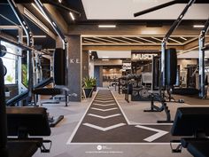 an indoor gym with machines and exercise equipment in the background, including treadmills