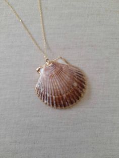 Beautiful gold plated scallop shell necklace made with a gold plated seashell charm with a gold filled chain.  This necklace makes a unique gift for a beach lover or someone special in your life. The seashell is around 50mm long. Each item is carefully packaged in a beautiful jewellery box ready as a gift. If you would like to add a personalized note with your order, just write a note at checkout and I will send a small card with your gift to the recipient. Please choose necklace length from the drop-down menu. If you need a bigger quantity or any customized jewellery for your very special occasion (birthdays, weddings, bridal showers or any other event), please send me a message and I'll be glad to help. Shell Shape Charm Necklace As A Gift, Shell Charm Necklace As A Gift, Gold Strand Charm Necklace As Gift, Gold Strand Charm Necklace For Gift, Gold Strand Jewelry For Gift, Shell Charm Necklaces As Gift, Beachy Gold Shell Necklace For Gifts, Beachy Gold Shell Necklace For Gift, Gold Beachy Necklace For Gifts