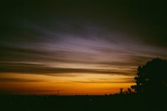 the sky is very dark and cloudy at night, with some clouds in the distance