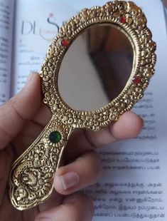 a person holding a mirror in their hand