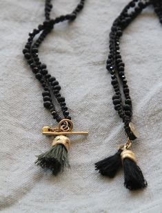 "Gold tassel eucalyptus fruit shape pendent made of brass with 22K gold plating (nickel free) and special hand made knitted black cotton thread with spinel and black miyuki chain. This Gold & black unique necklace is handmade with great attention to details, the organic golden piece is cast originally from nature and this is what makes each pendant different from one other. It is lightweight and comfortable to wear (the cotton chain it is a great solution for people with metal allergies), su Handmade Adjustable Gold Tassel Necklace, Bohemian Black Hand Knotted Jewelry, Black Tassel Necklace With Adjustable Fit, Adjustable Black Tassel Necklace, Adjustable Black Hand Knotted Necklace, Black Hand Knotted Adjustable Necklace, Elegant Black Tassel Necklace, Black Tassel Necklaces As Gift, Black Tassel Necklace Gift